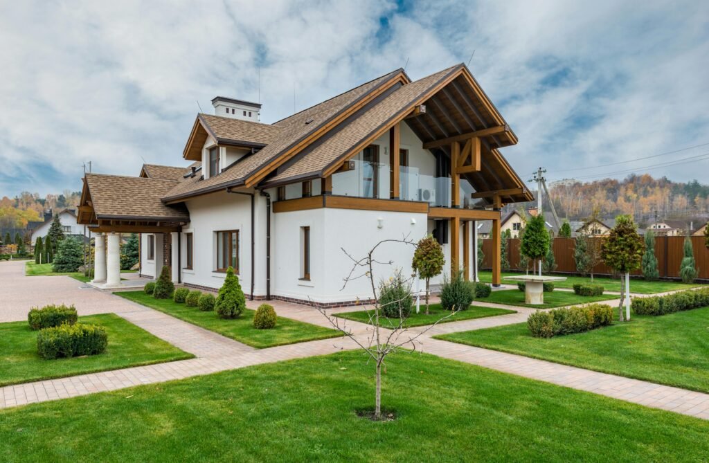 Architectural Design Services 2 Secondary Dwelling Units. Architectural Design Services. Exterior of modern cottage house with columns and balcony surrounded by green grass and trees